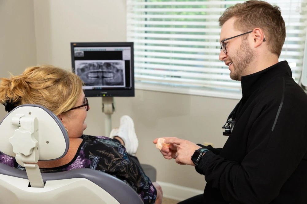 Dr. Shine talking with a patient in a dental exam room at Shine Family Dentistry in Garner, NC.